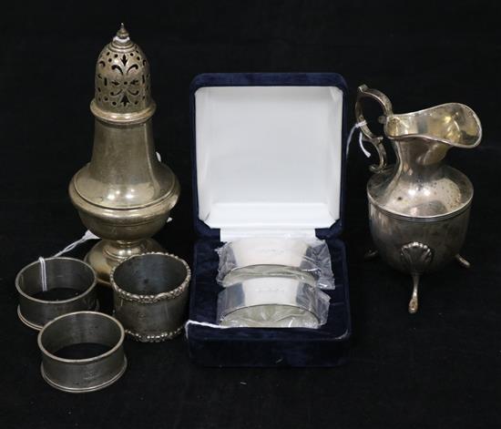 A silver castor, a cream jug and sundries